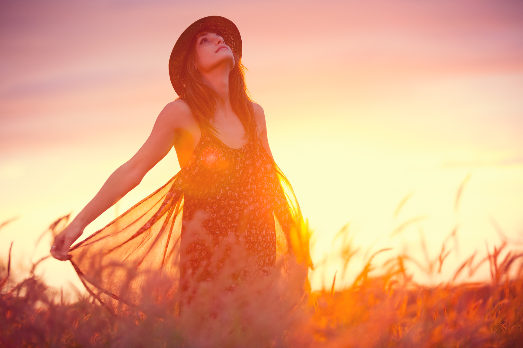 Beautiful woman in golden field at sunset - Ida Andersen Lang